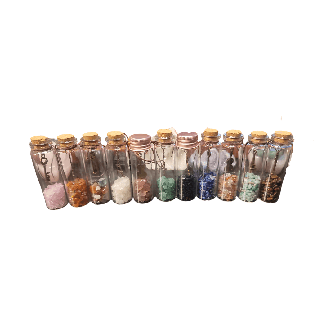Twelve glass bottles with cork stoppers containing various colored stones and crystals.